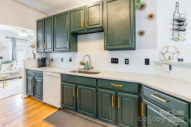 a kitchen with stainless steel appliances a sink stove and cabinets