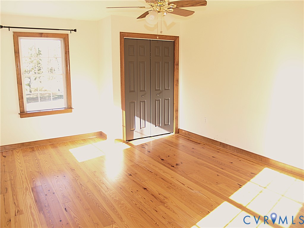 11950 Union Camp Road New Kent, VA 23124 - Photo 11 of 20 a view of an empty room with wooden floor and a window