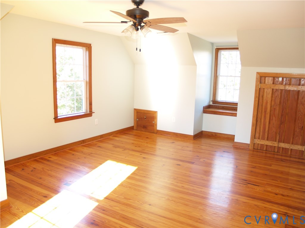 11950 Union Camp Road New Kent, VA 23124 - Photo 14 of 20 a view of an empty room with wooden floor and a window