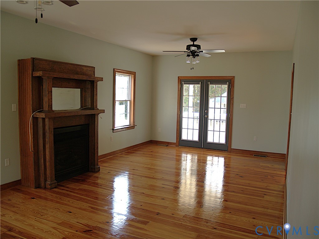 11950 Union Camp Road New Kent, VA 23124 - Photo 4 of 20 a view of an empty room with wooden floor and a window