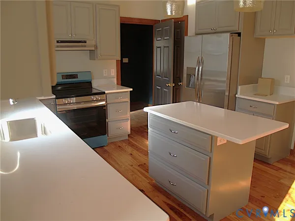 a kitchen with a refrigerator and a stove