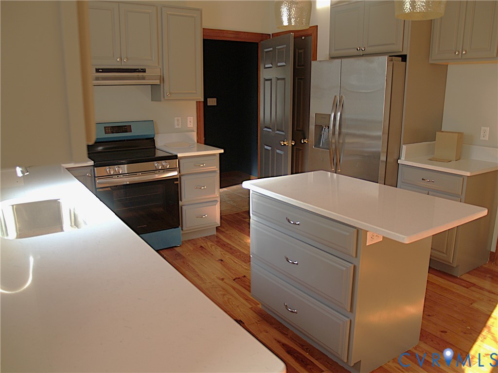 11950 Union Camp Road New Kent, VA 23124 - Photo 6 of 20 a kitchen with a refrigerator and a stove