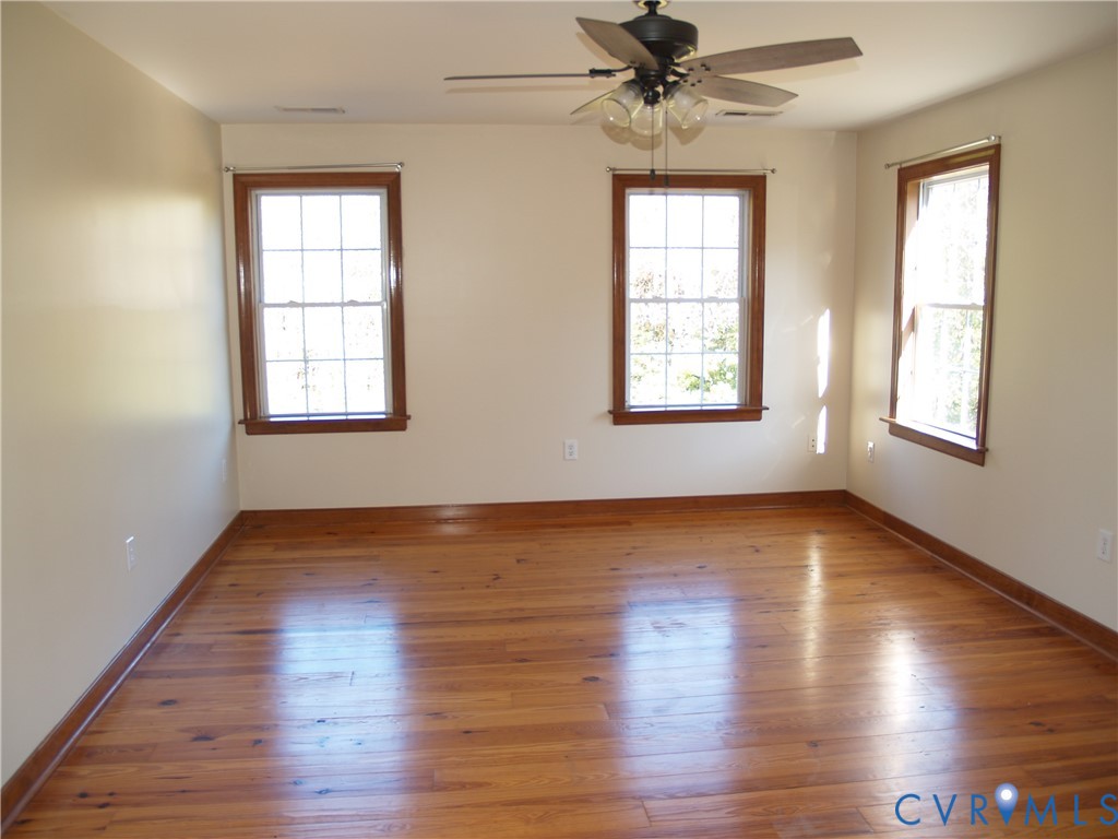 11950 Union Camp Road New Kent, VA 23124 - Photo 7 of 20 a view of an empty room with wooden floor and a window