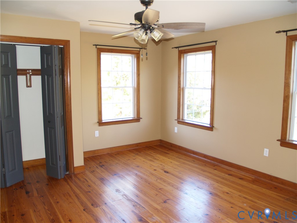 11950 Union Camp Road New Kent, VA 23124 - Photo 10 of 20 a view of an empty room with window and wooden floor