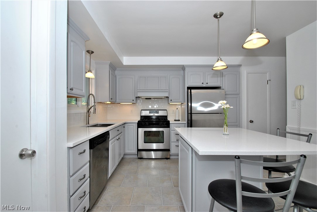 1091 Haverston Road Lyndhurst, OH 44124 - Photo 9 of 27 Kitchen has stainless appliances and large island/breakfast bar