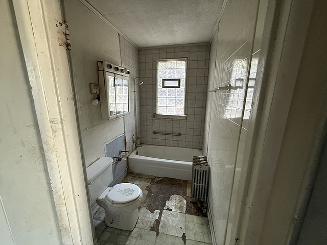 7711 South Champlain Avenue Chicago, IL 60619 - Photo 13 of 19 a bathroom with a granite countertop sink toilet and shower
