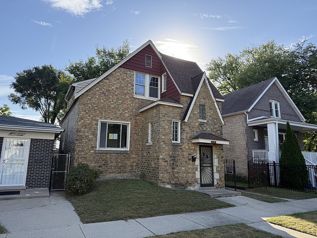 7711 South Champlain Avenue Chicago, IL 60619 - Photo 16 of 19 a front view of a house with garden
