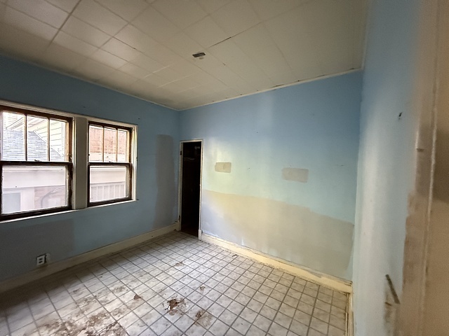 7711 South Champlain Avenue Chicago, IL 60619 - Photo 7 of 19 an empty room with windows
