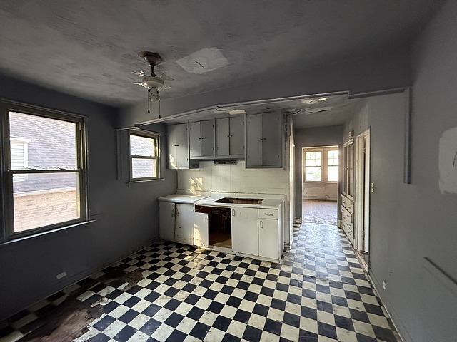 7711 South Champlain Avenue Chicago, IL 60619 - Photo 10 of 19 a kitchen with granite countertop stainless steel appliances a stove a sink and a window