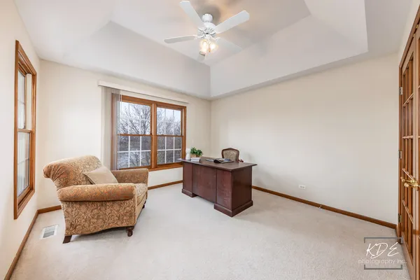 a spacious bedroom with a bed and a dresser