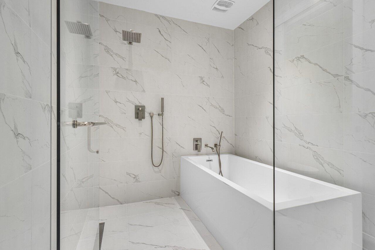 3100 North Ocean Drive, Unit H1205 Singer Island, FL 33404 - Photo 14 of 35 a bathroom with a bathtub and shower