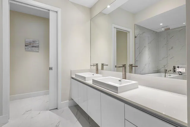 a bathroom with 2 sink tub and a mirror