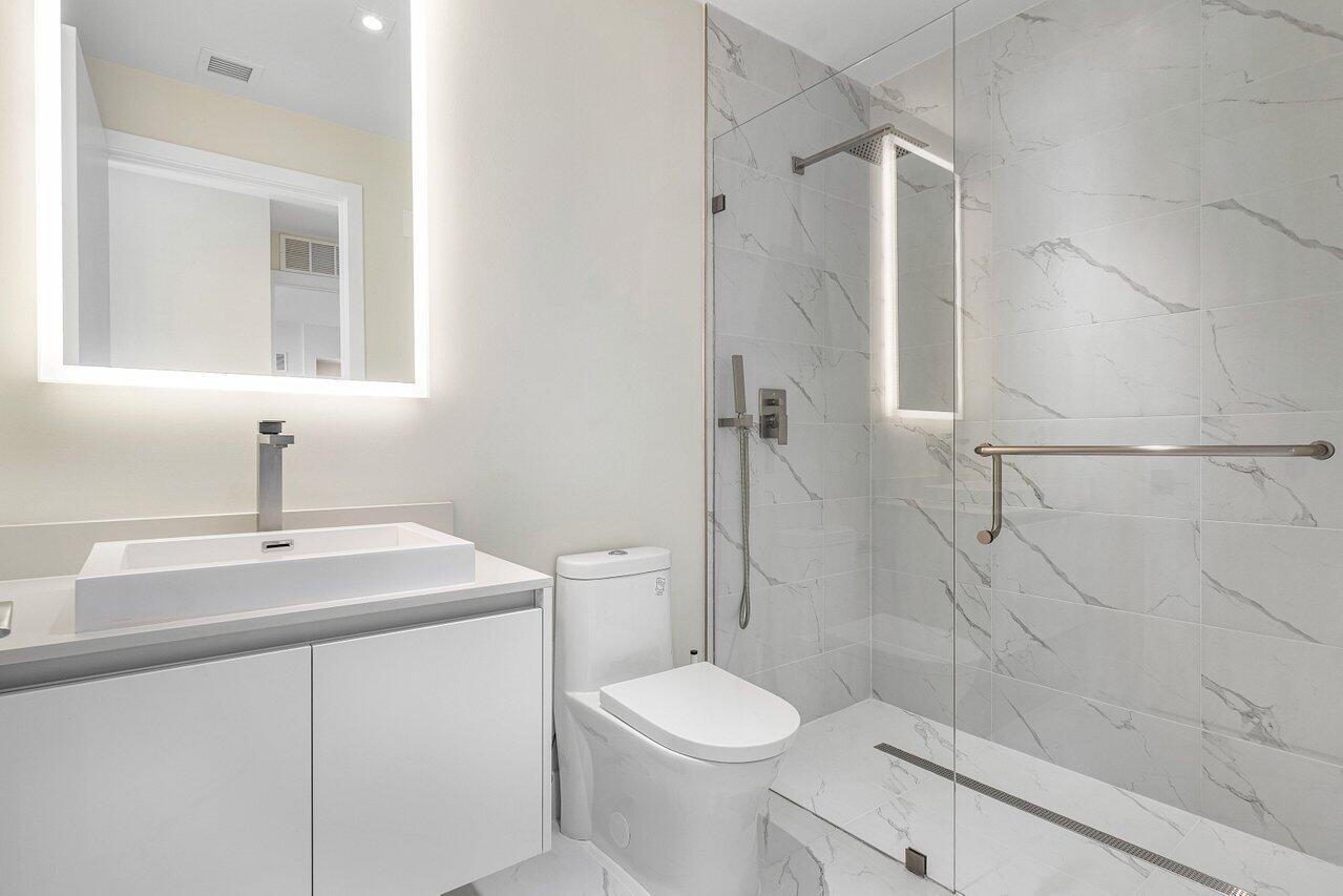 3100 North Ocean Drive, Unit H1205 Singer Island, FL 33404 - Photo 17 of 35 a bathroom with a sink a toilet and shower