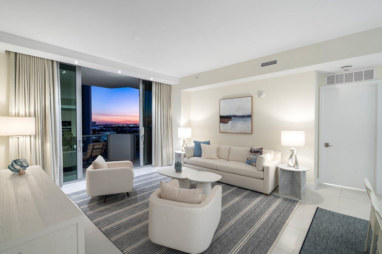 3100 North Ocean Drive, Unit H1205 Singer Island, FL 33404 - Photo 8 of 35 a living room with furniture and a flat screen tv