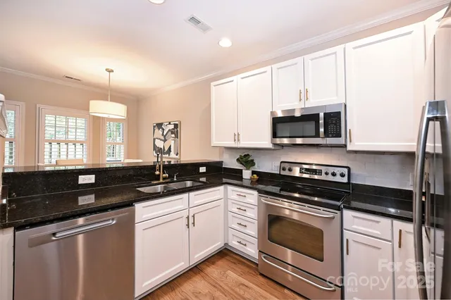a kitchen with a sink stove and microwave