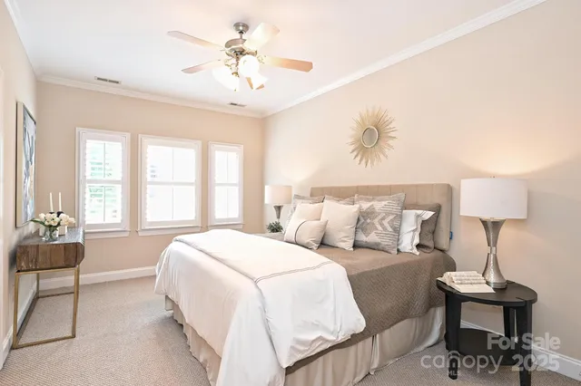 a spacious bedroom with a bed and a chandelier