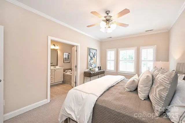 a bedroom with a large bed and a chandelier