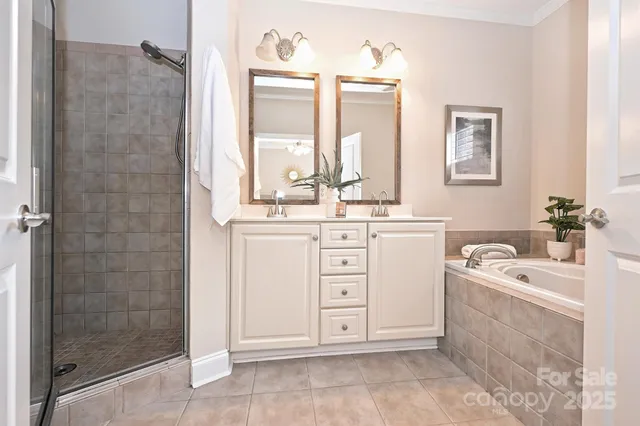 a bathroom with a double vanity sink a mirror and a shower
