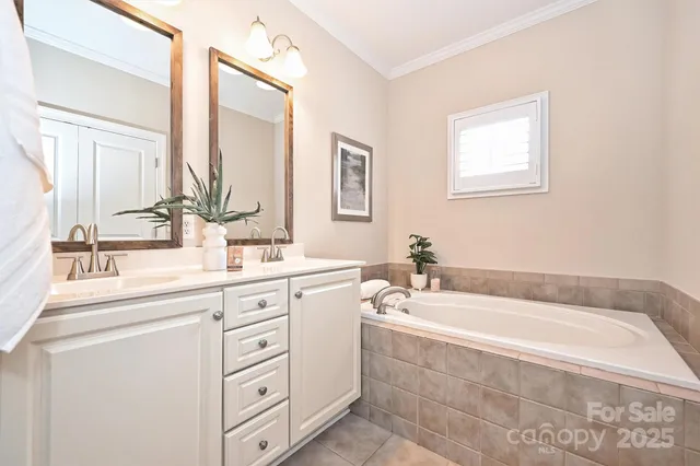a bathroom with a bathtub a sink a mirror a and vanity