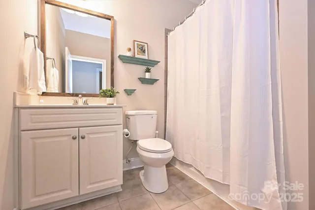 a bathroom with a sink toilet and a mirror
