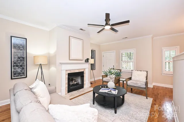 a living room with furniture a window and a fireplace