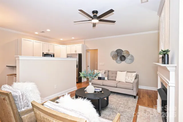 a living room with furniture and kitchen view