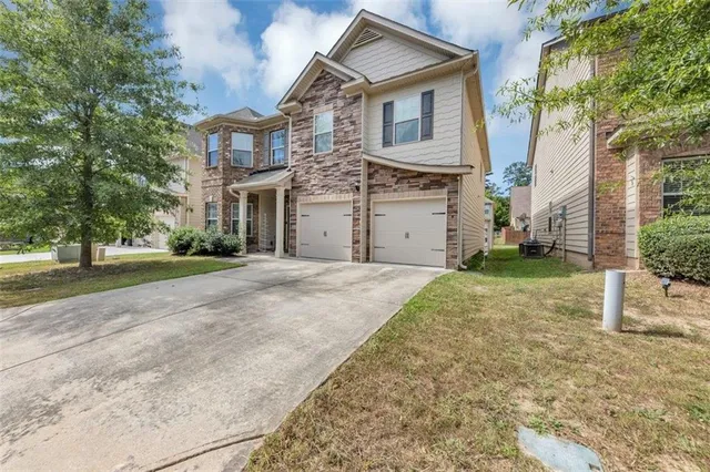 a front view of a house with a yard