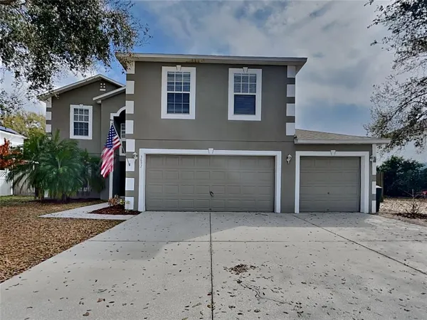a view of a house with a yard and garage