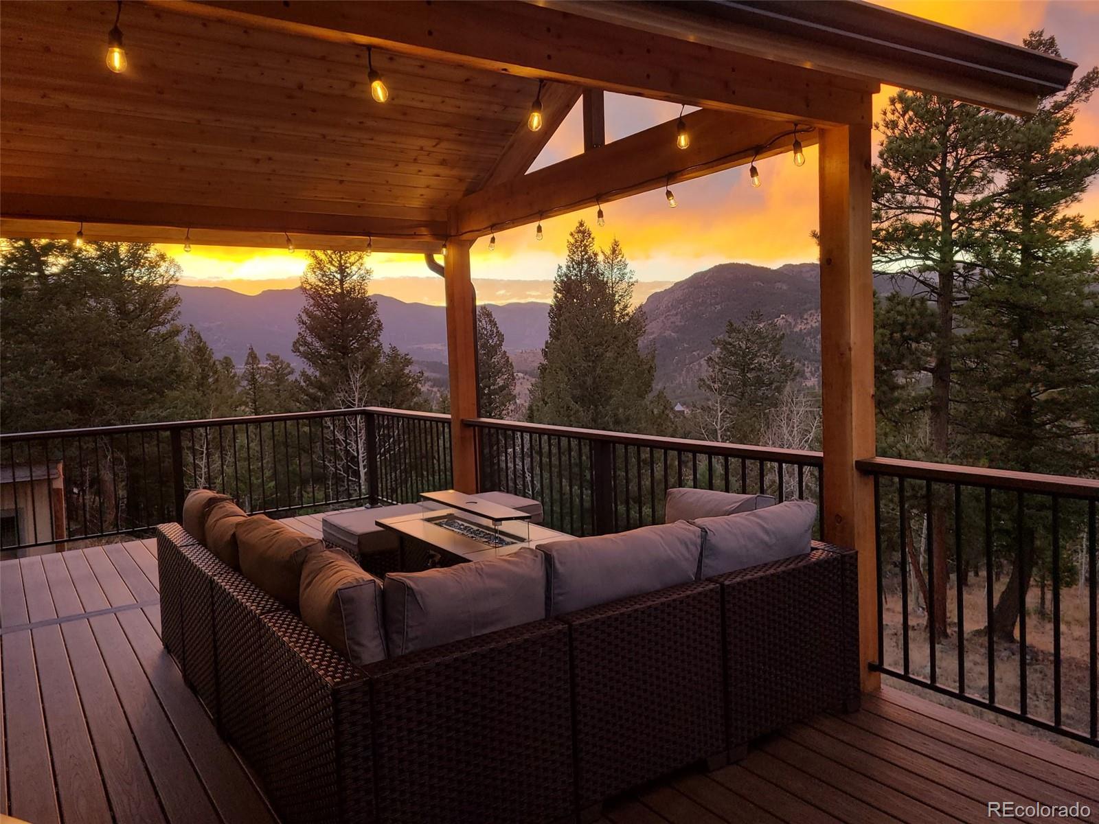 a view of a two couches and table in the deck