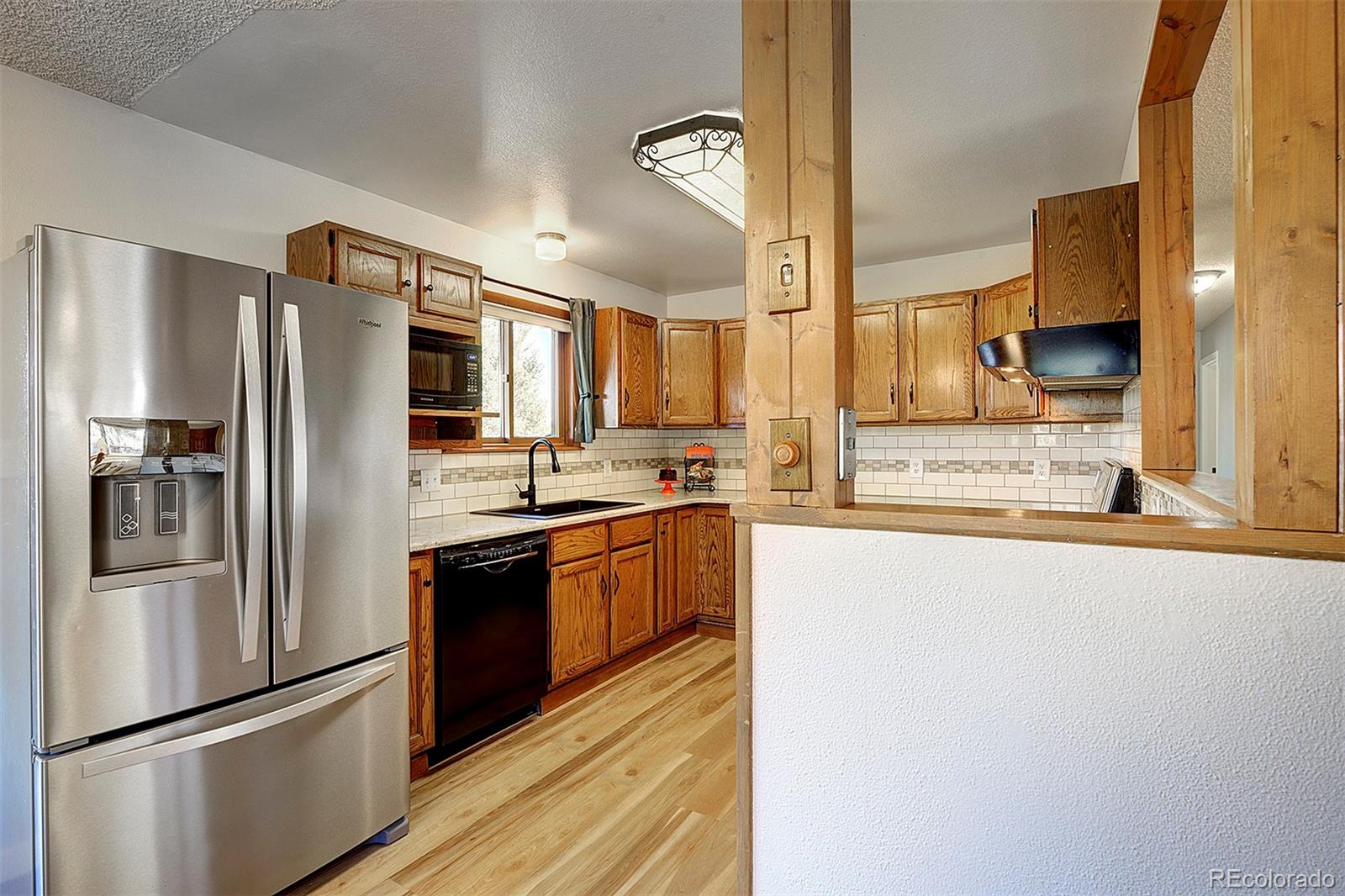 81 Fir Lane Bailey, CO 80421 - Photo 11 of 33 a kitchen with stainless steel appliances granite countertop a refrigerator and a stove top oven