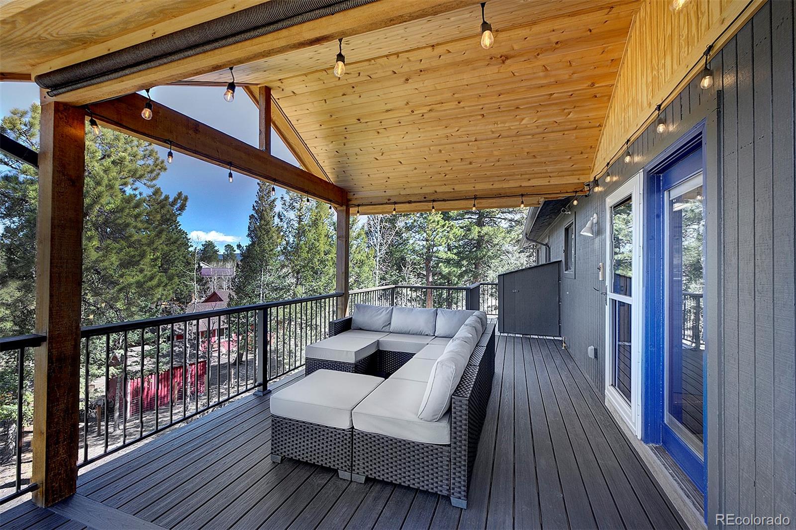 81 Fir Lane Bailey, CO 80421 - Photo 25 of 33 a view of a balcony with couch and wooden floor