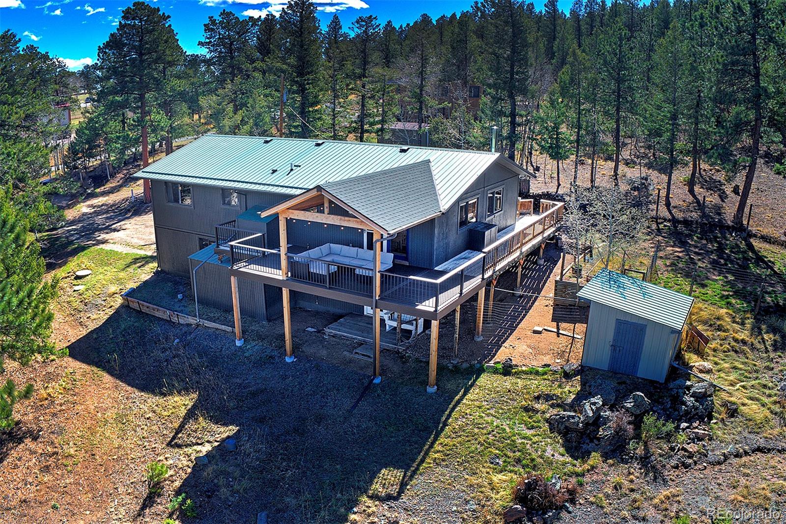 81 Fir Lane Bailey, CO 80421 - Photo 4 of 33 a aerial view of a house with roof deck outdoor seating