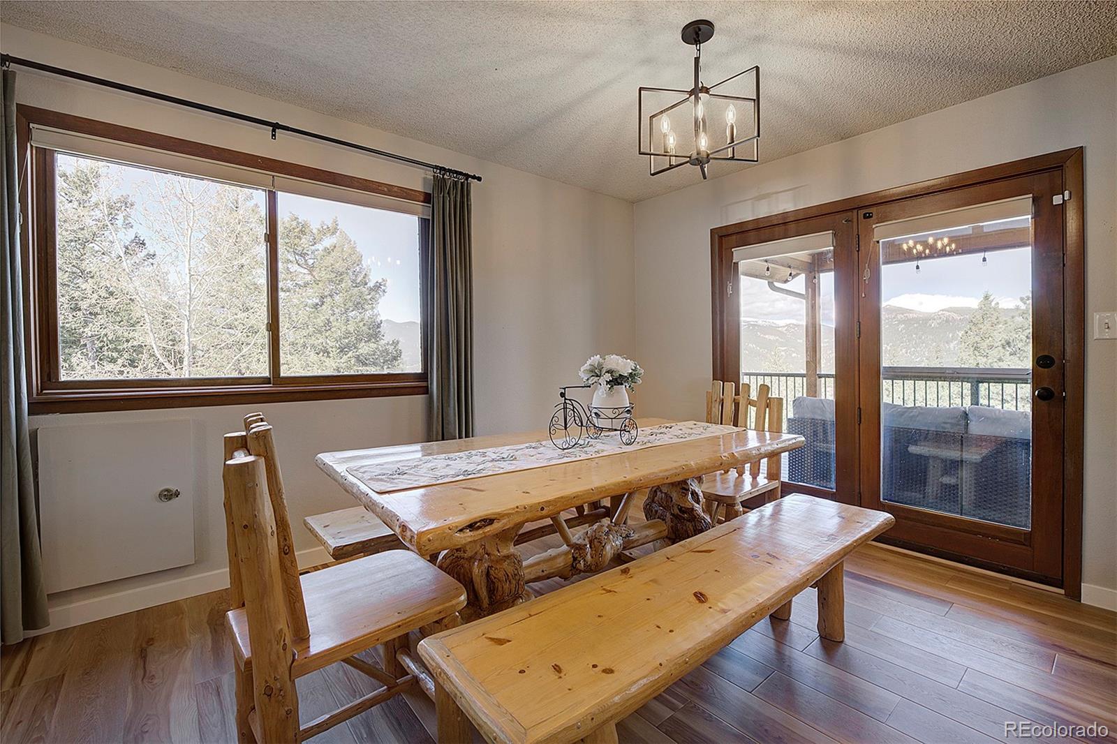 81 Fir Lane Bailey, CO 80421 - Photo 8 of 33 a view of a dining room with furniture window and wooden floor