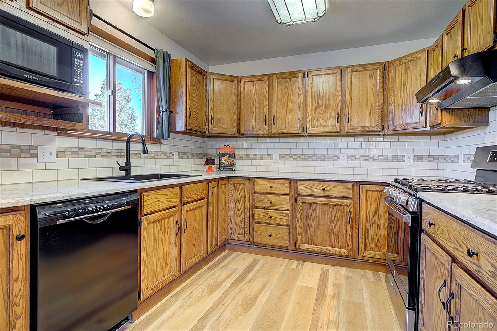 81 Fir Lane Bailey, CO 80421 - Photo 10 of 33 a kitchen with stainless steel appliances granite countertop a sink stove and cabinets