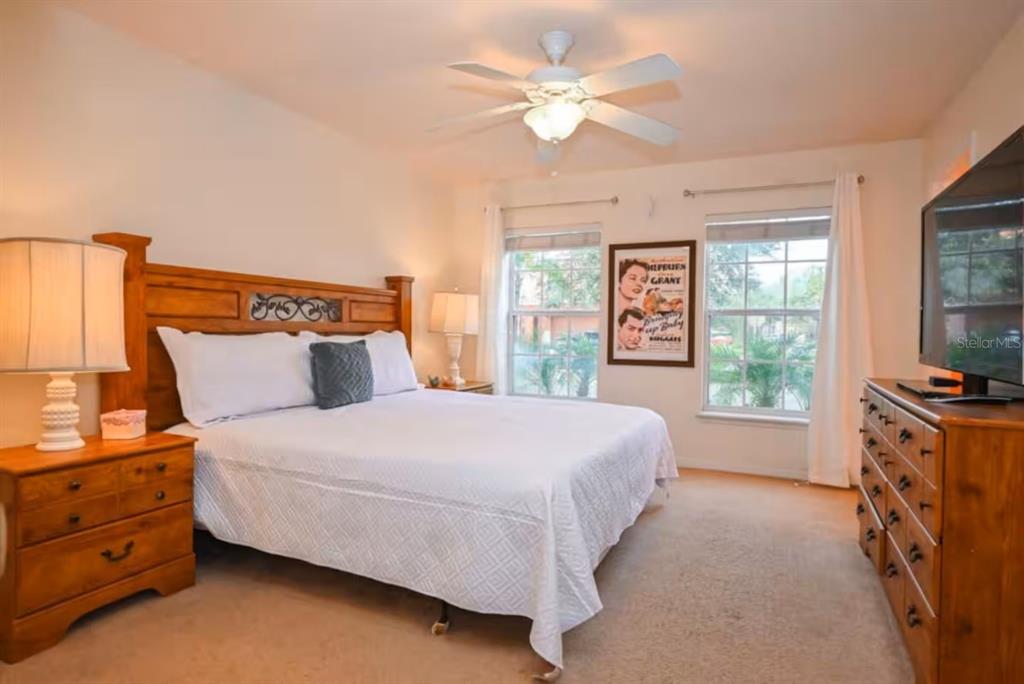 1904 Royal Ridge Drive Davenport, FL 33896 - Photo 8 of 15 a bedroom with a large bed and a tv