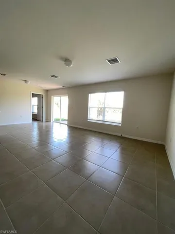 a view of an empty room and a window