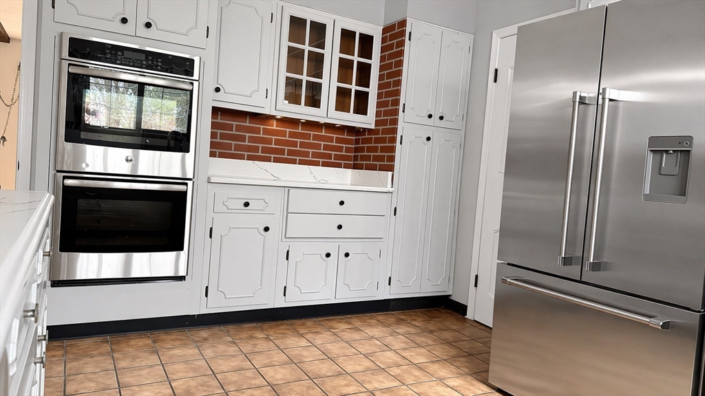 12 Woodland Road Westfield, MA 01085 - Photo 13 of 29 a kitchen with stainless steel appliances a refrigerator and cabinets
