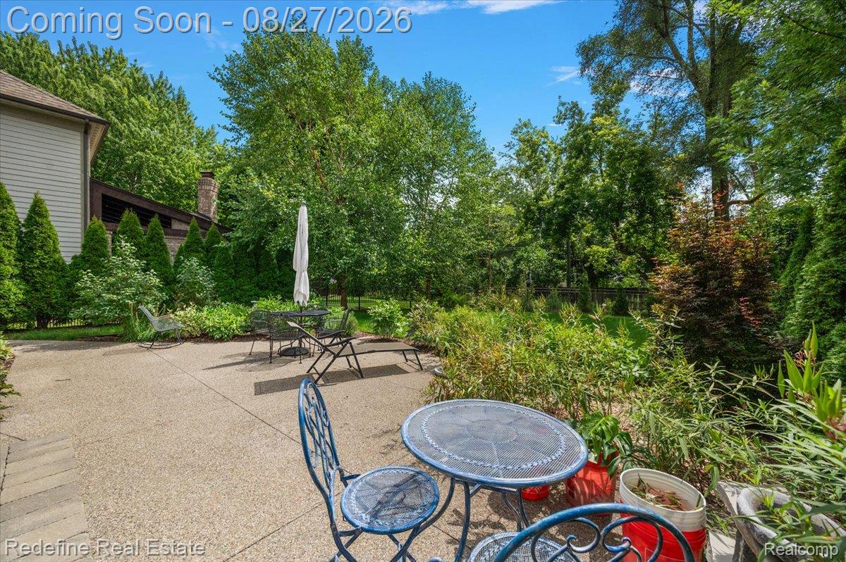 149 Woodward Avenue Rochester, MI 48307 - Photo 40 of 51 Expansive hardscape patio with mature landscaping and wooded backdrop
