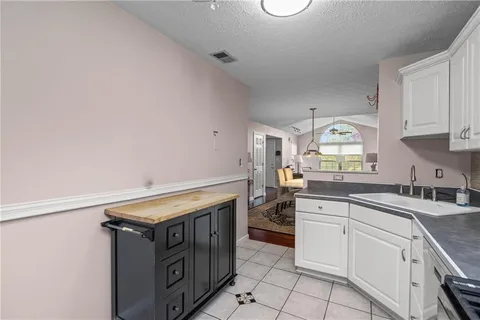 a kitchen that has a sink and a stove in it