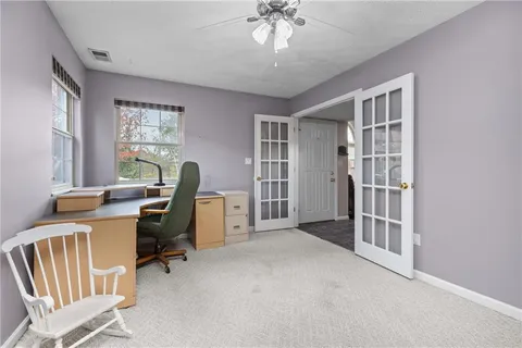 a view of a livingroom with workspace and a window