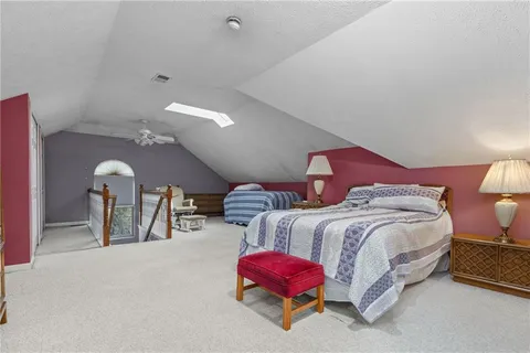 a bedroom with two beds and a lamp