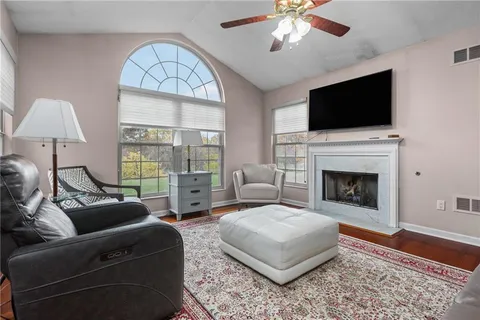 a living room with furniture fireplace and a flat screen tv