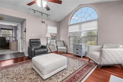 a living room with furniture a chandelier and a rug