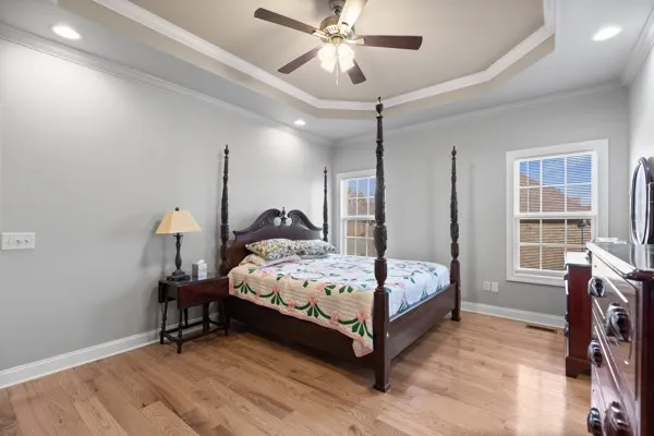 a bedroom with a bed and a chandelier