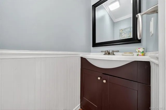 a bathroom with a sink vanity and a mirror
