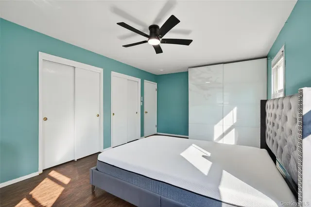 a bed room with a bed and a ceiling fan
