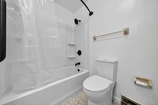 a bathroom with a bathtub and a toilet