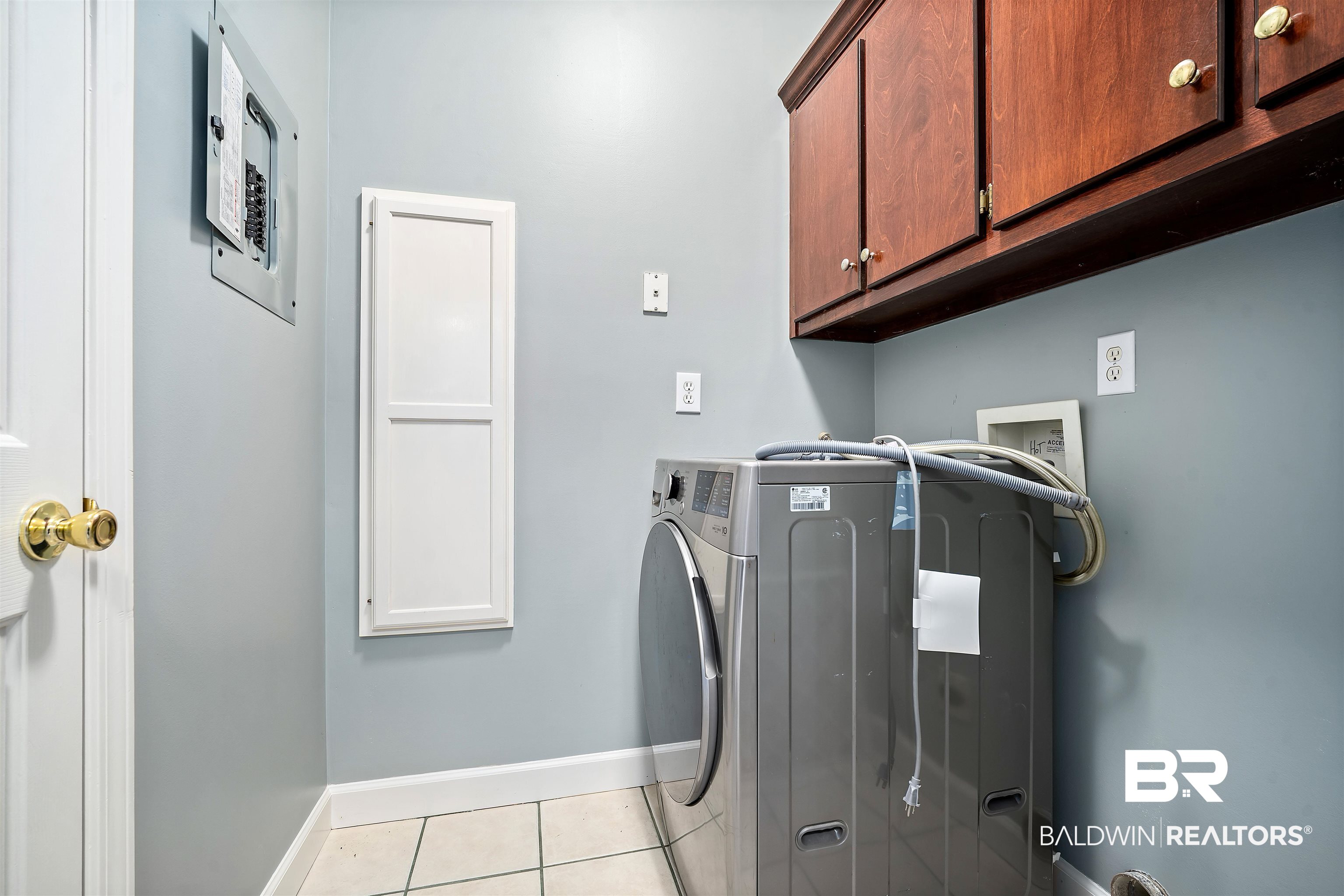 615 Summerlake Place Mobile, AL 36608 - Photo 30 of 35 Washroom featuring light tile patterned flooring, cabinet space, separate washer and dryer, and electric panel