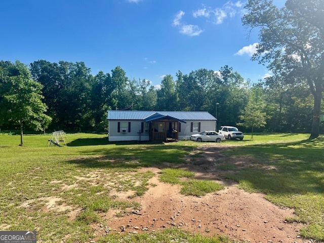 3400 Veal Road Sandersville, GA 31082 - Photo 1 of 1 a view of a house with a yard