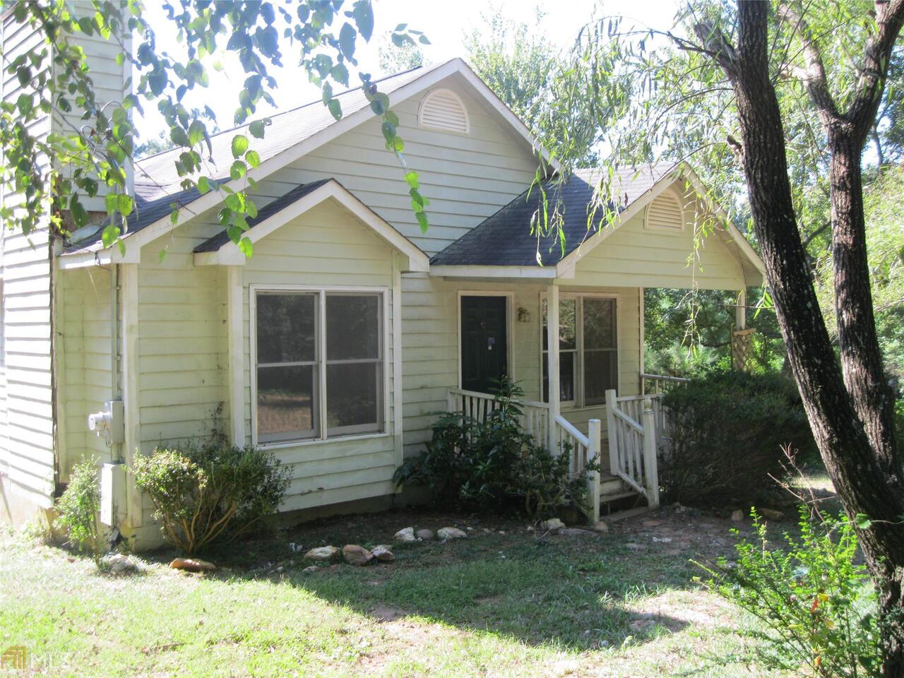 119 Mosley Road Bremen, GA 30110 - Photo 1 of 1 a front view of a house with a yard and potted plants